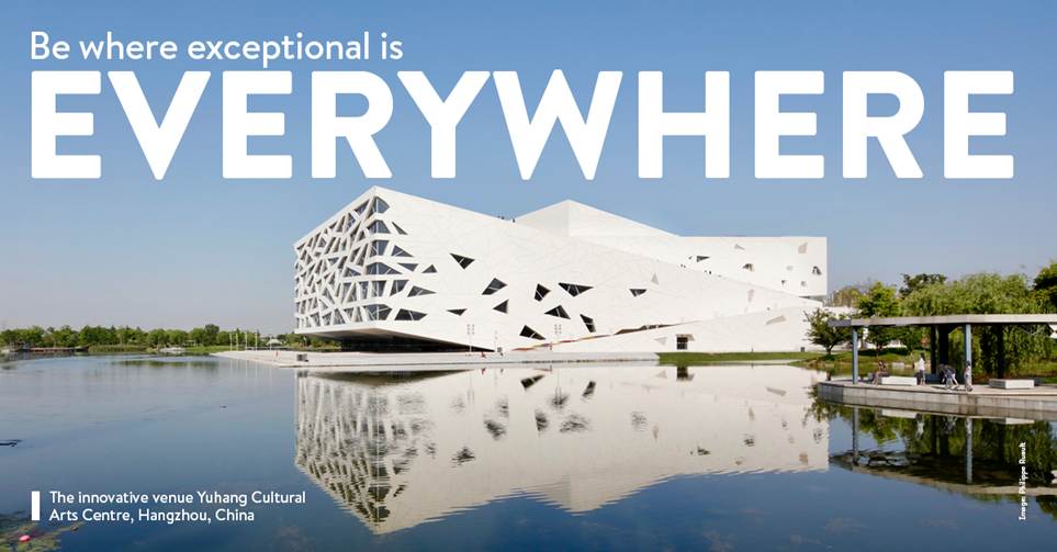 A white building with a reflection of waterDescription automatically generated